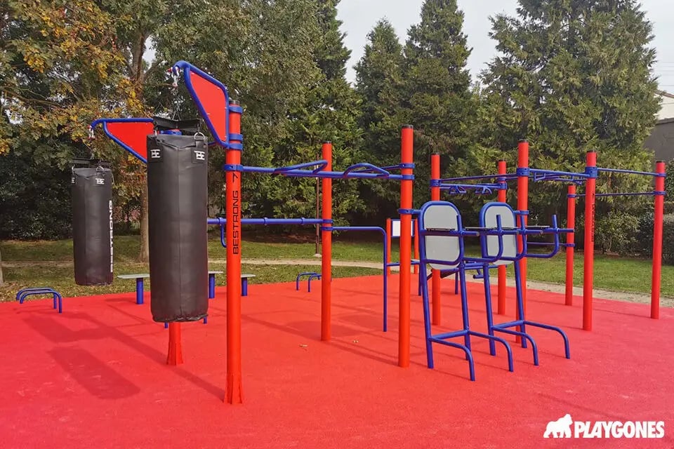 outdoor gym uses bright red rubber flooring underneath workout equipment